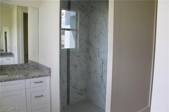 bathroom featuring vanity and a tile shower