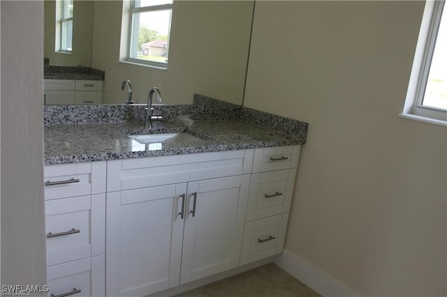 bathroom with vanity and plenty of natural light