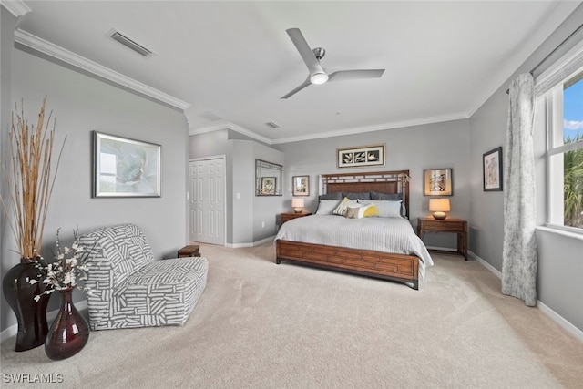 carpeted bedroom with ornamental molding, a closet, and ceiling fan