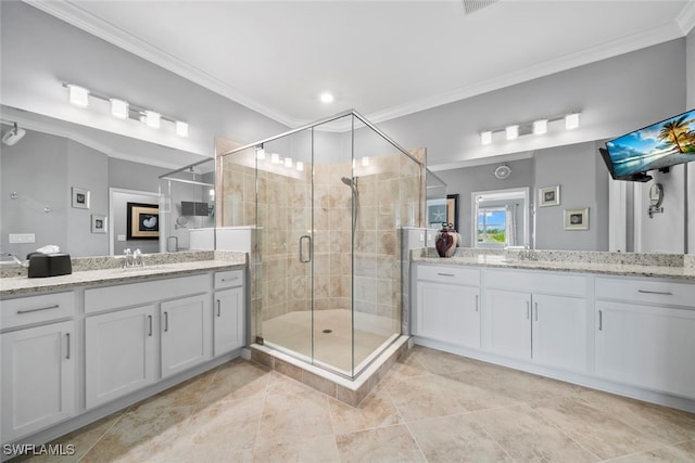 bathroom featuring a shower with door, vanity, and crown molding