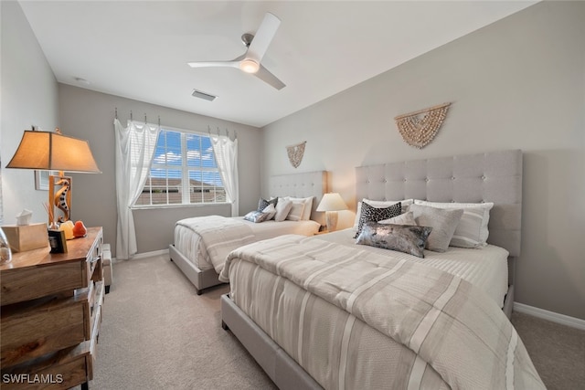 bedroom with ceiling fan and light colored carpet