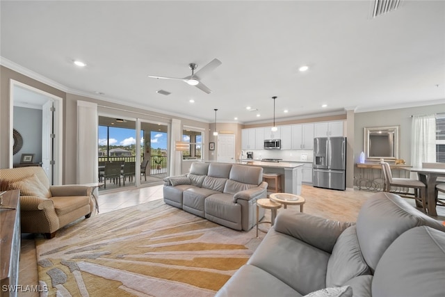 tiled living room featuring ceiling fan and ornamental molding