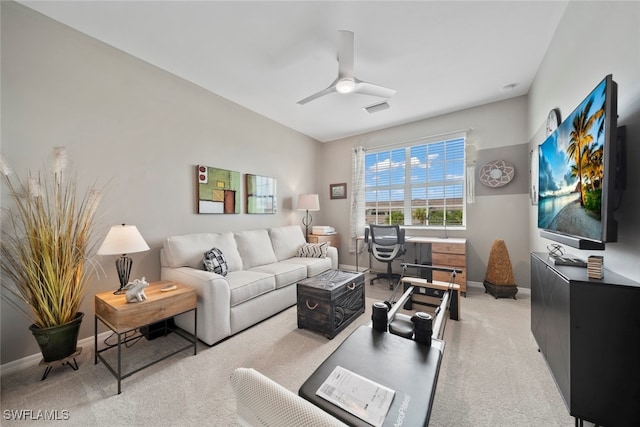 carpeted living room with ceiling fan