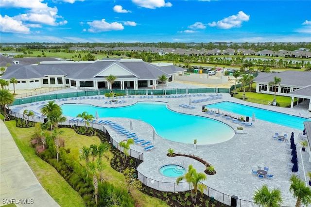 view of swimming pool with a patio area and a community hot tub