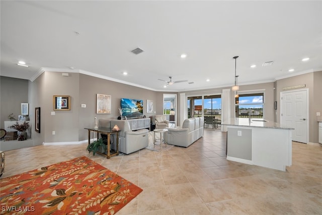 tiled living room with ceiling fan and ornamental molding