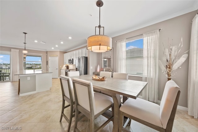 dining space featuring ornamental molding and light tile patterned flooring