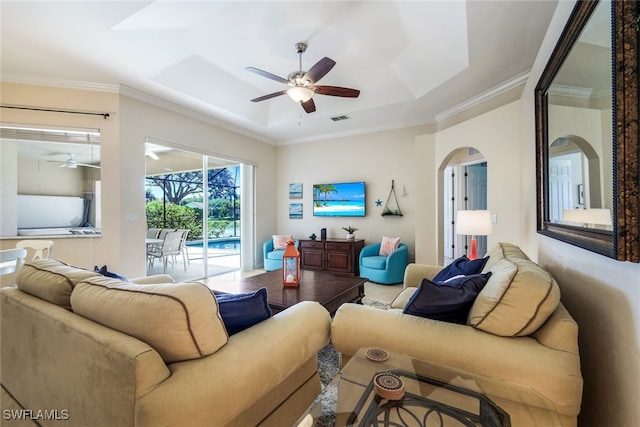 living room featuring ceiling fan and ornamental molding