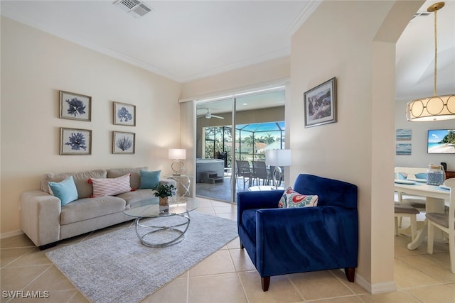 living room with crown molding and light tile patterned floors