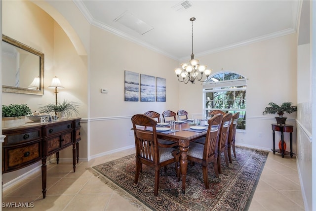 dining space with crown molding, light tile patterned flooring, and an inviting chandelier