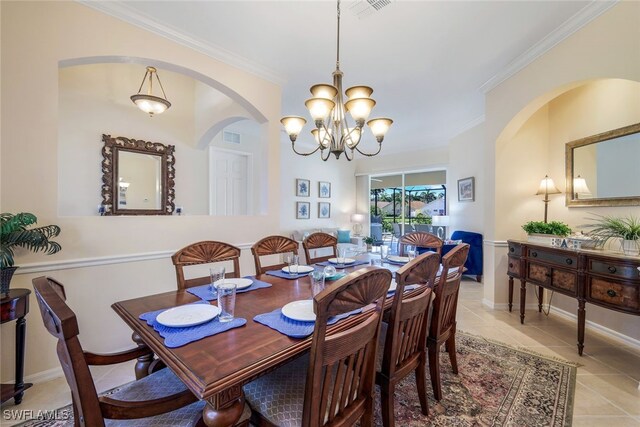 tiled dining space with crown molding and an inviting chandelier