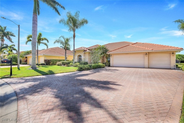 mediterranean / spanish-style home featuring a garage and a front lawn