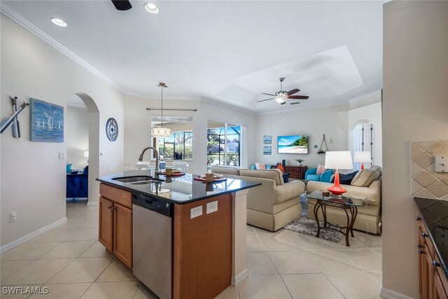 kitchen featuring dishwasher, an island with sink, sink, pendant lighting, and light tile patterned floors