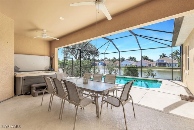 view of patio / terrace with a water view, ceiling fan, and glass enclosure