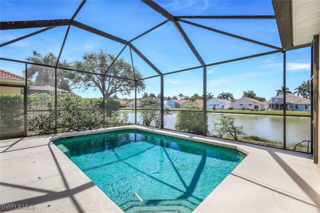 view of swimming pool with a patio, a lanai, and a water view