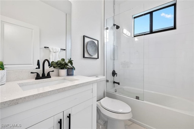 full bathroom featuring vanity, tiled shower / bath combo, and toilet