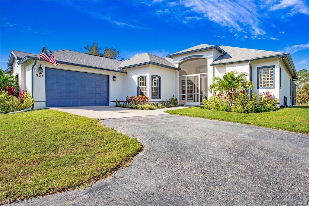 view of front facade with a garage and a front lawn