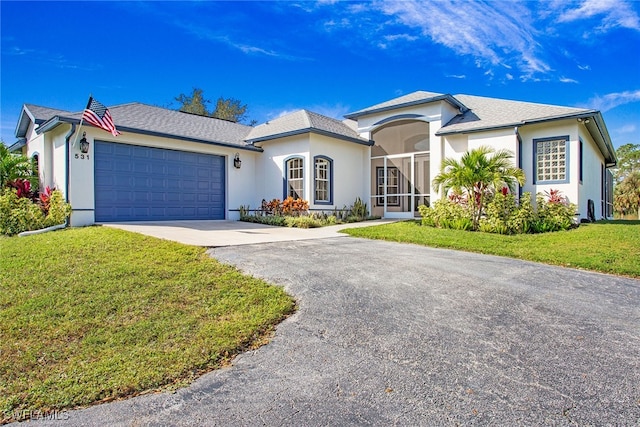 view of front facade with a garage and a front lawn