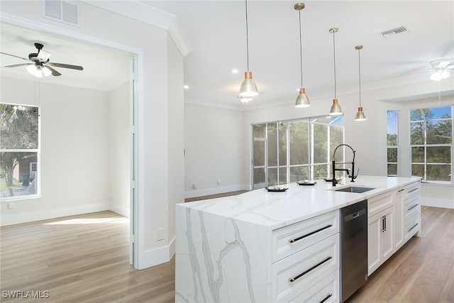 kitchen with sink, light stone counters, a kitchen island with sink, white cabinets, and dishwasher