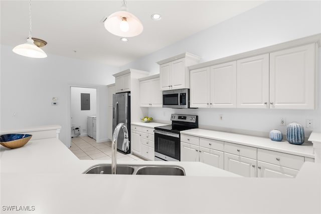 kitchen with light tile patterned floors, white cabinetry, stainless steel appliances, sink, and decorative light fixtures