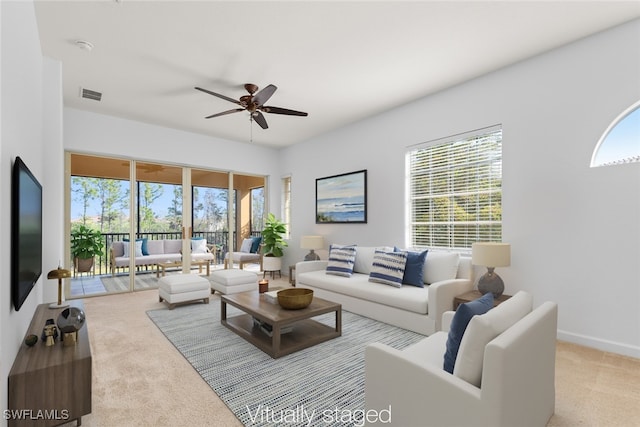 living room with light carpet and ceiling fan