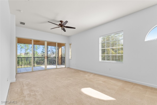 unfurnished room featuring light carpet and ceiling fan