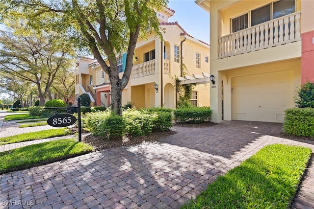 view of front of house featuring a balcony and a garage