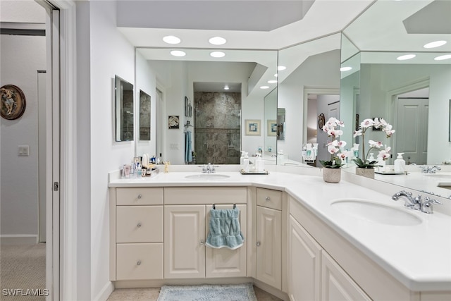 bathroom with vanity and tiled shower