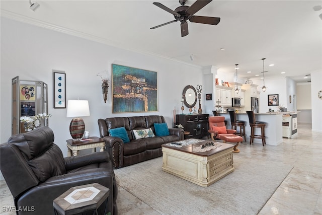 living room featuring ornamental molding and ceiling fan