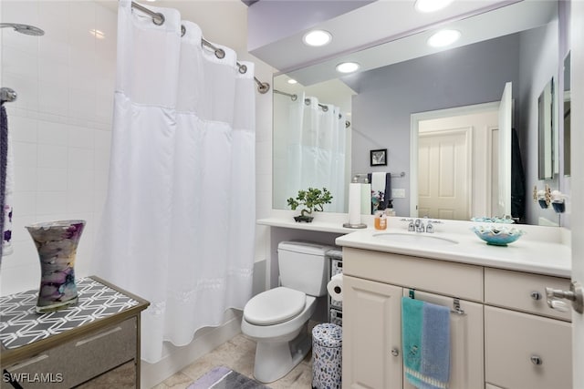 bathroom with vanity, toilet, and tile patterned floors