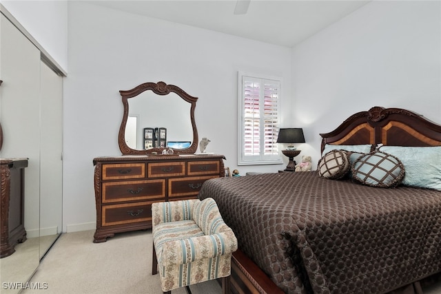 bedroom with light carpet, a closet, and ceiling fan