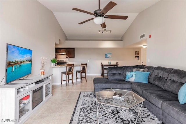 tiled living room featuring lofted ceiling and ceiling fan