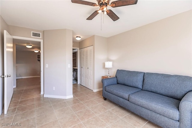 living room featuring light tile patterned floors and ceiling fan