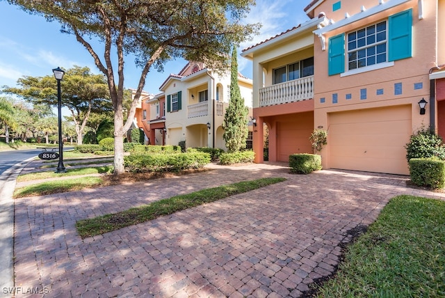 view of front of home featuring a balcony and a garage