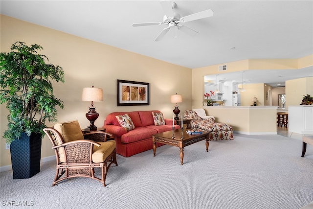 carpeted living room with ceiling fan