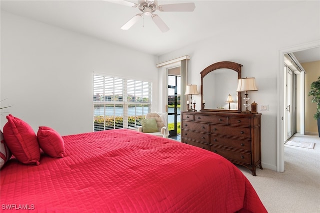 carpeted bedroom featuring a water view, ceiling fan, and access to outside