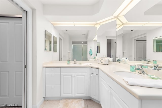 bathroom featuring vanity, a shower with shower door, and tile patterned floors