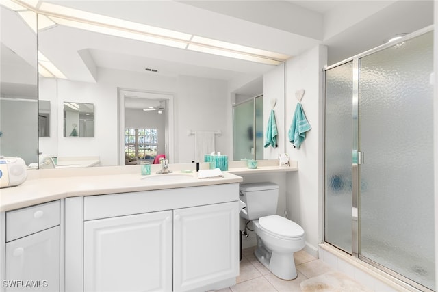 bathroom featuring vanity, a shower with shower door, toilet, and tile patterned flooring