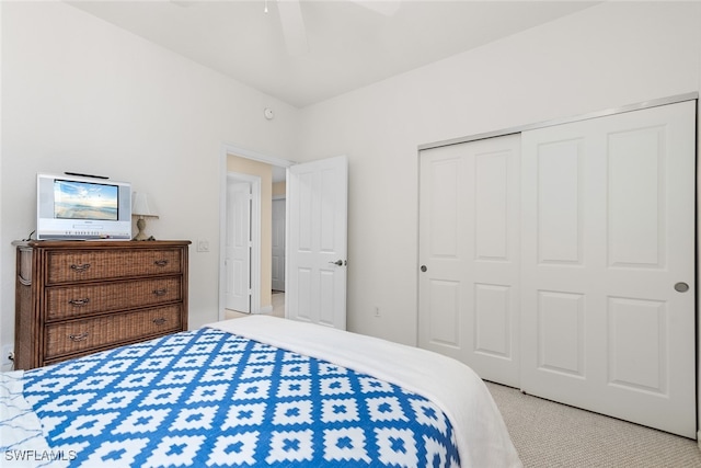 carpeted bedroom featuring a closet and ceiling fan