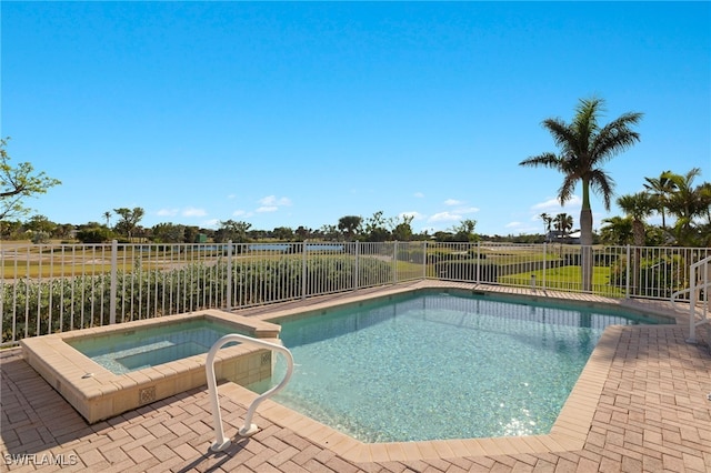 view of pool with a patio area and an in ground hot tub