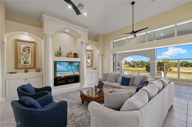 tiled living room featuring decorative columns and ceiling fan