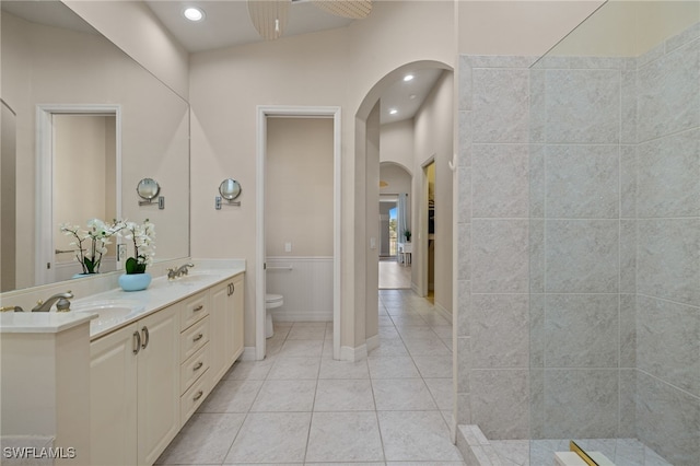 bathroom featuring tile patterned floors, vanity, ceiling fan, and toilet