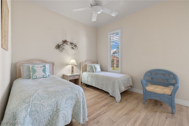 bedroom with ceiling fan and light hardwood / wood-style floors