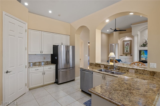 kitchen featuring sink, kitchen peninsula, ceiling fan, white cabinetry, and stainless steel appliances