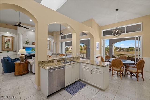 kitchen with dishwasher, ceiling fan with notable chandelier, white cabinets, and sink