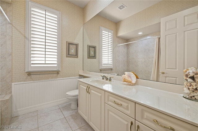 bathroom featuring tile patterned floors, vanity, and toilet