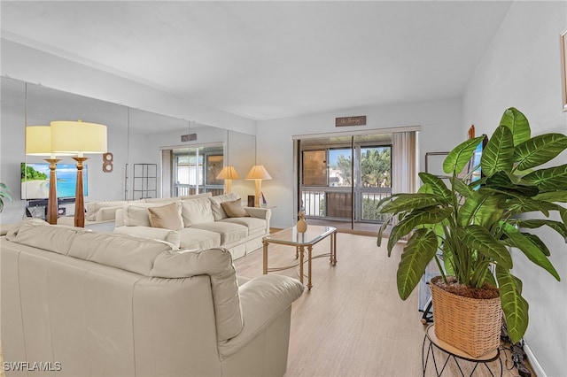 living room featuring light hardwood / wood-style flooring and a healthy amount of sunlight