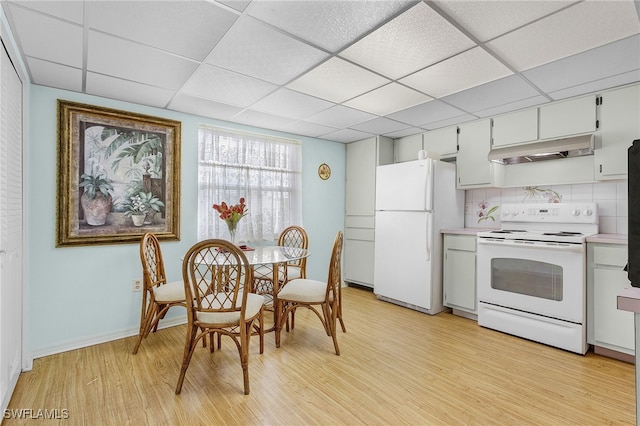 kitchen featuring light hardwood / wood-style floors, white cabinets, a paneled ceiling, white appliances, and tasteful backsplash