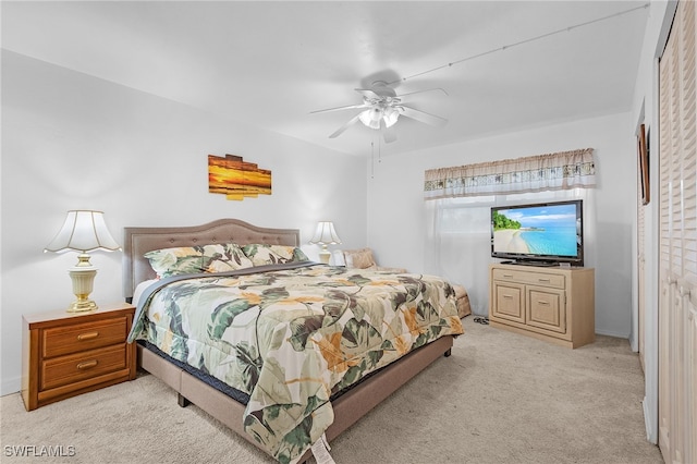 bedroom featuring light colored carpet and ceiling fan