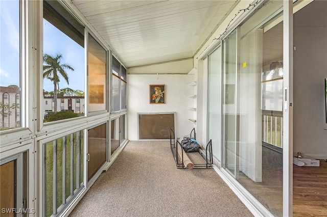 sunroom / solarium featuring vaulted ceiling and a wealth of natural light