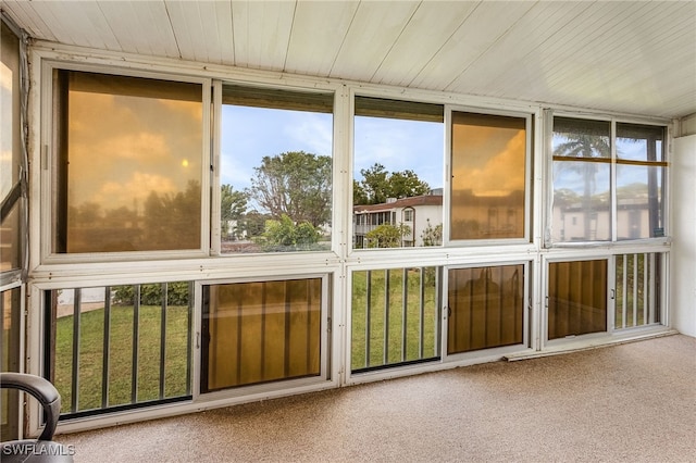 unfurnished sunroom with wooden ceiling